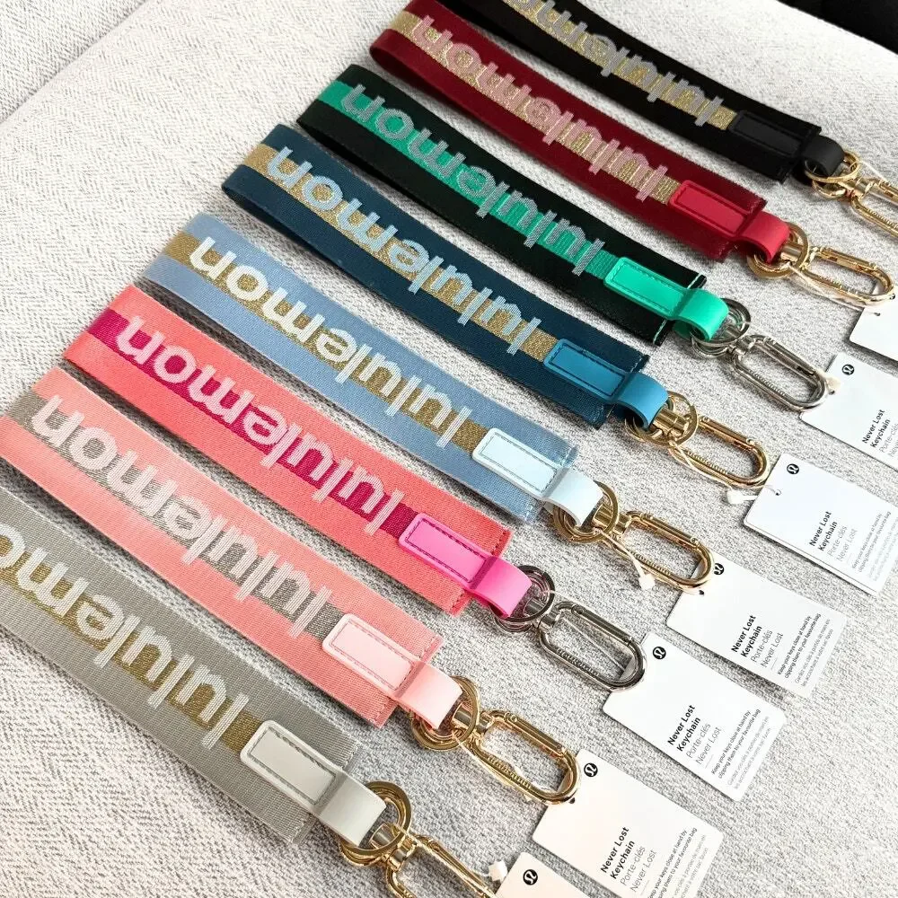 NEW Lululemon Never lost Keychain Wordmark Gray and Gold
